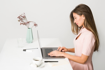 Recieptionist standing behind a desk at boutique recruitment agency
