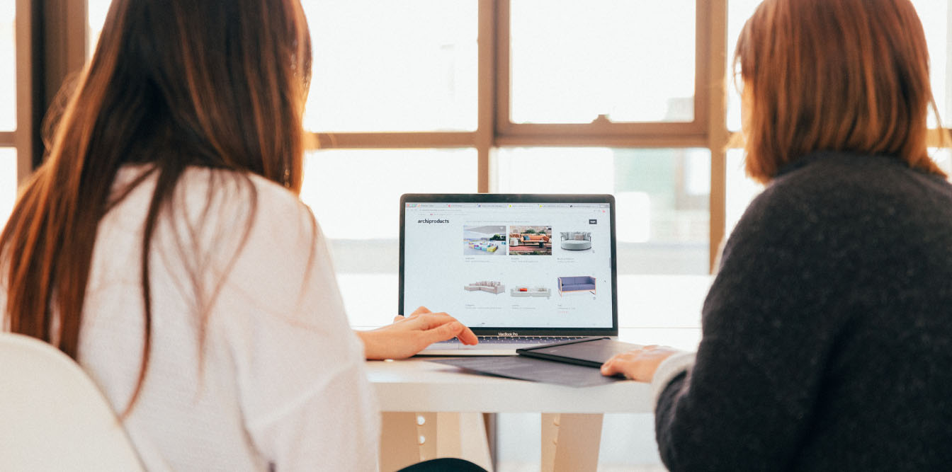 Two women working collaboratively on a project