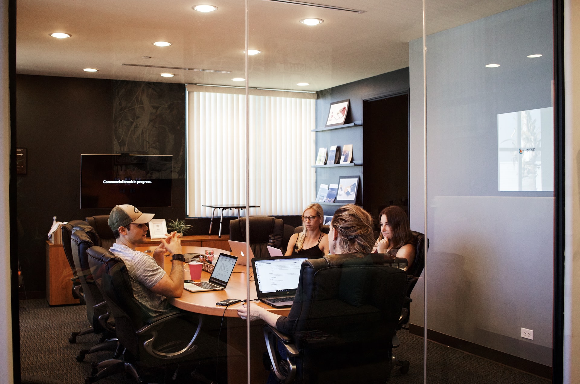 HR professionals reviewing resumes in a bright meeting room