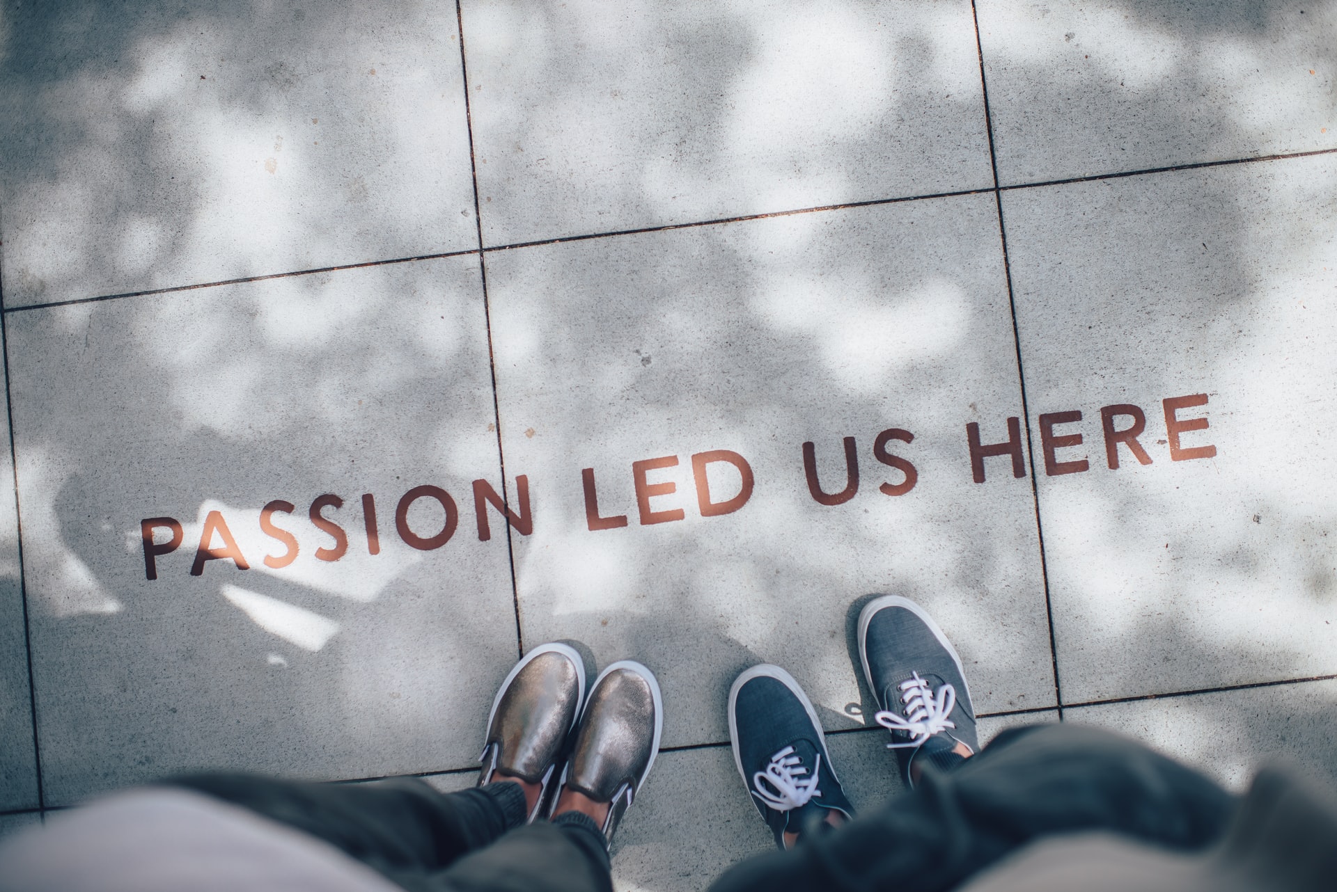 Pavement with the writing 'PASSION LED US HERE'