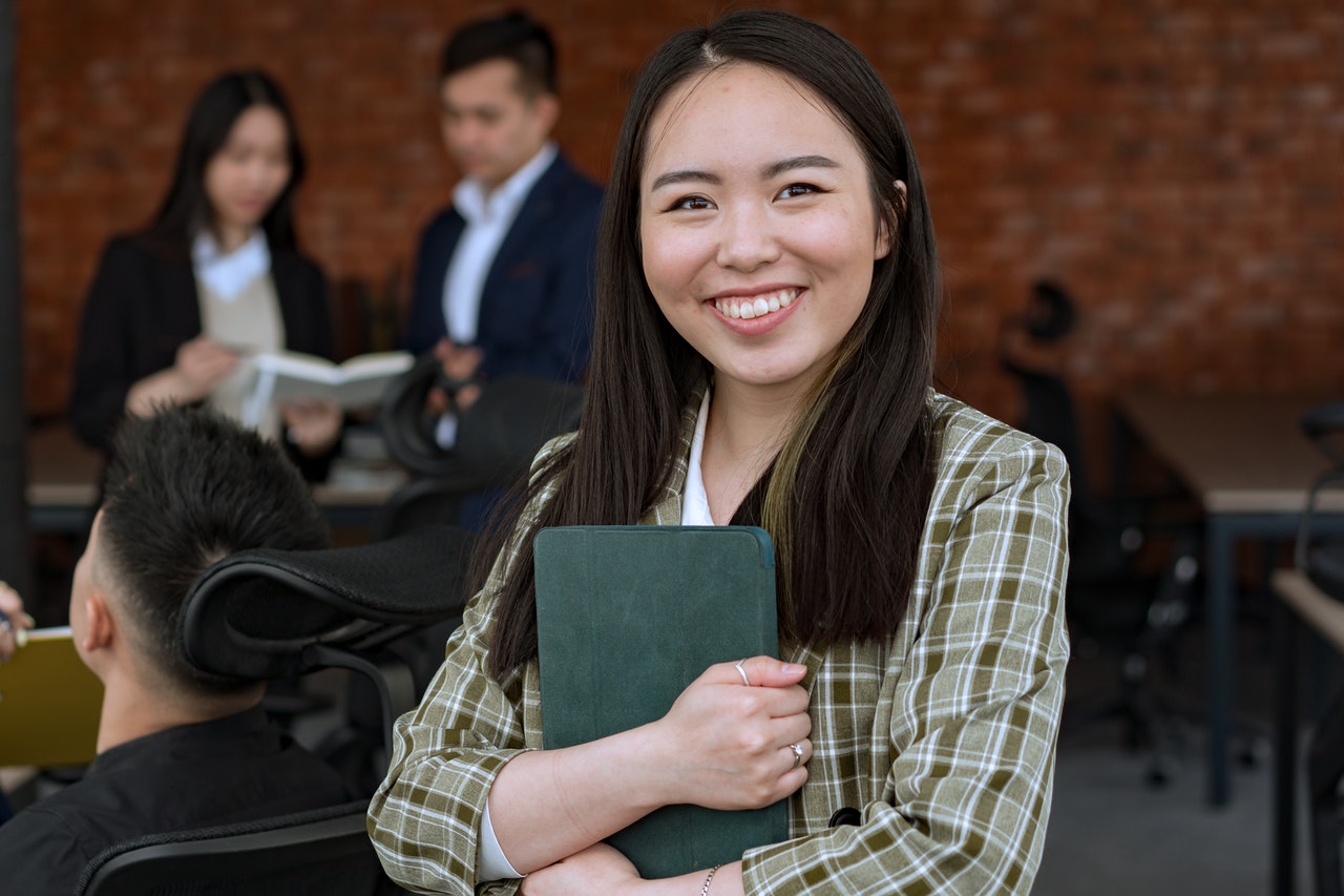 Temp smiling at a visitor in a modern office