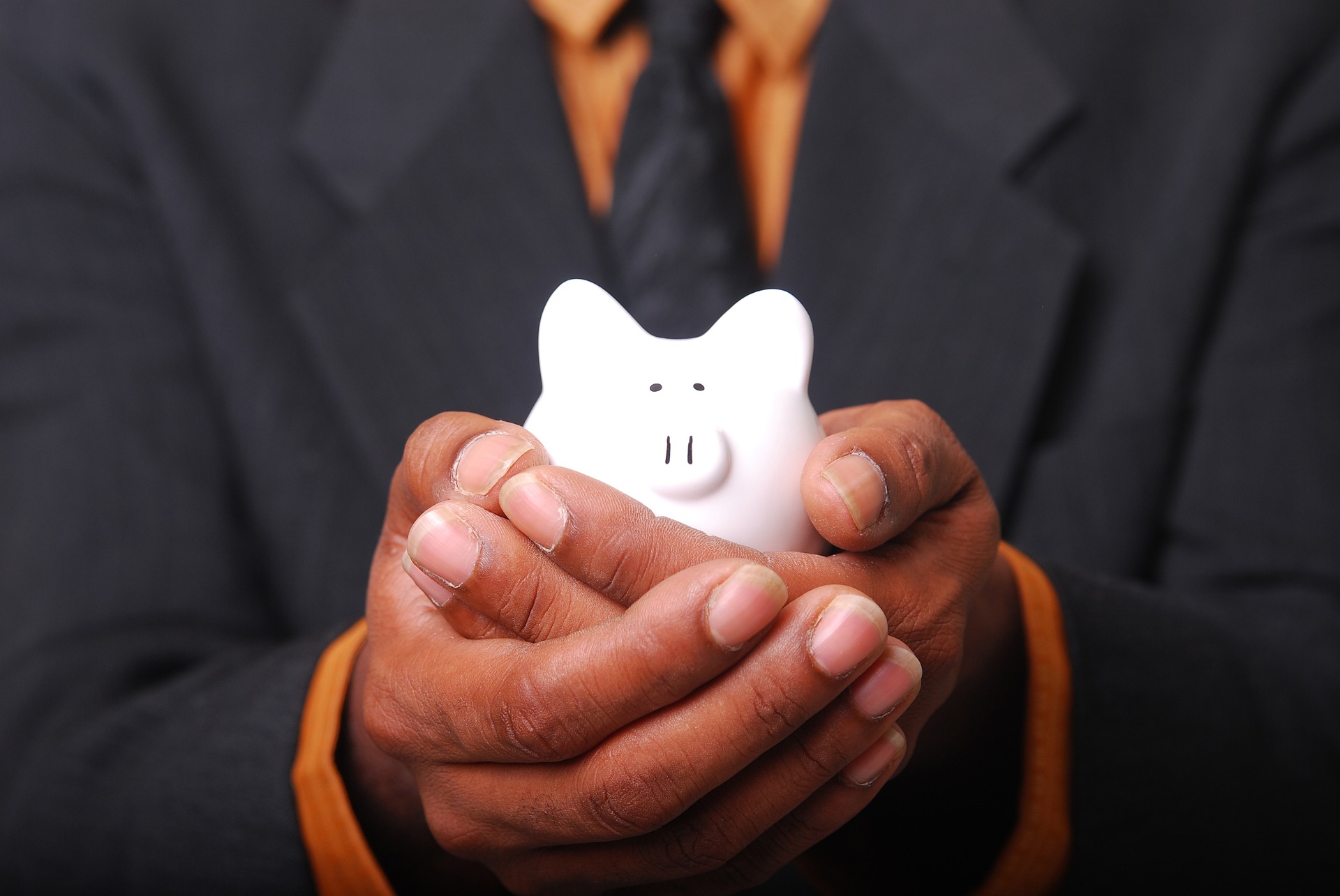 Piggy bank held in hand