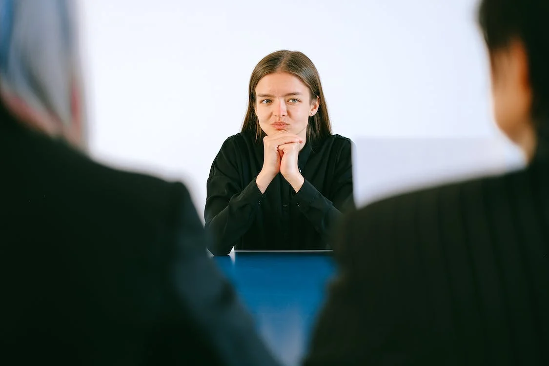A woman being asked interview questions for a temp position.