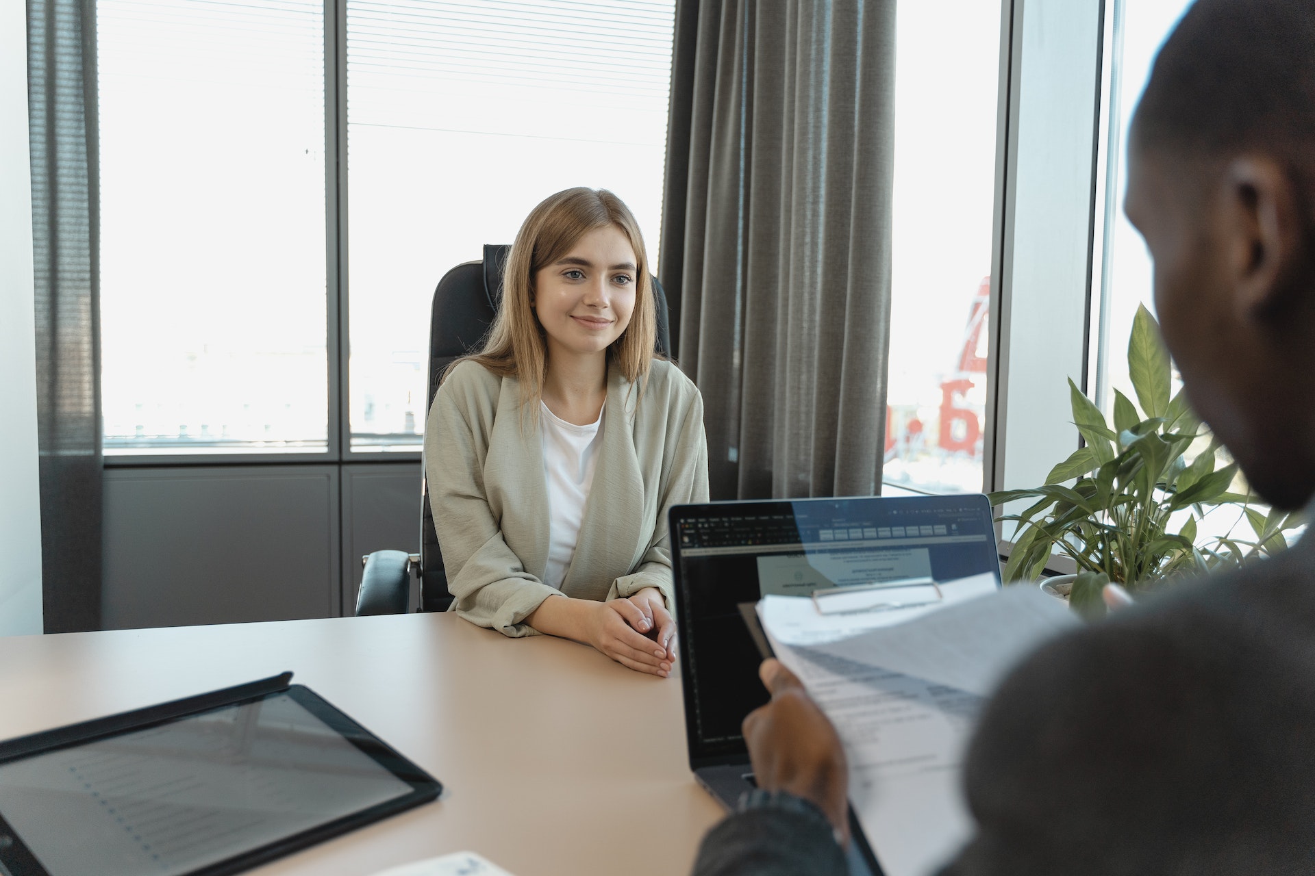 A woman is being interviewed for an administrative assistant role.