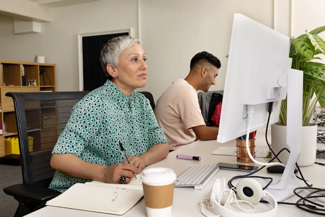 Person working at computer managing payroll for temp staff