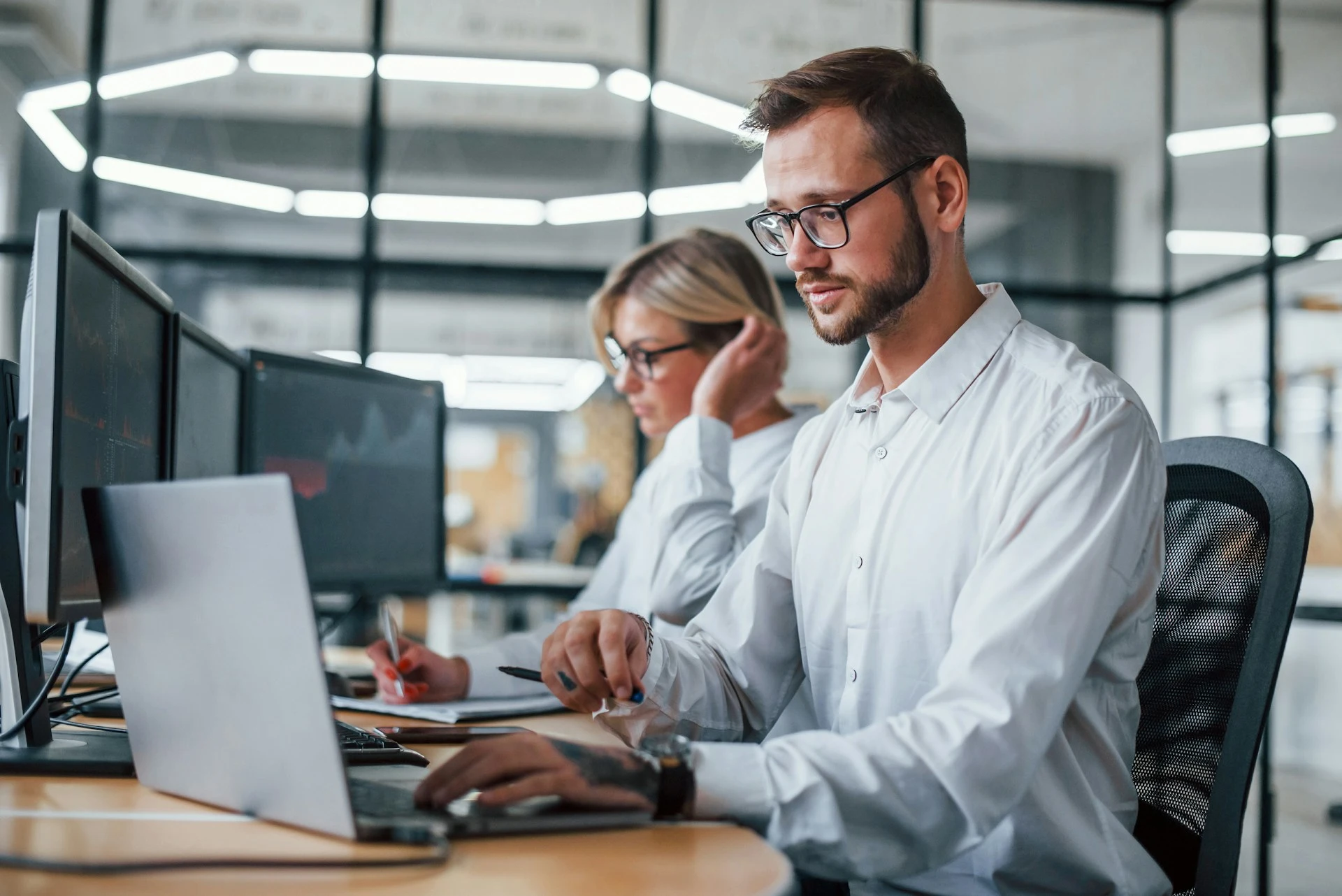 Two temporary employees working at their computers
