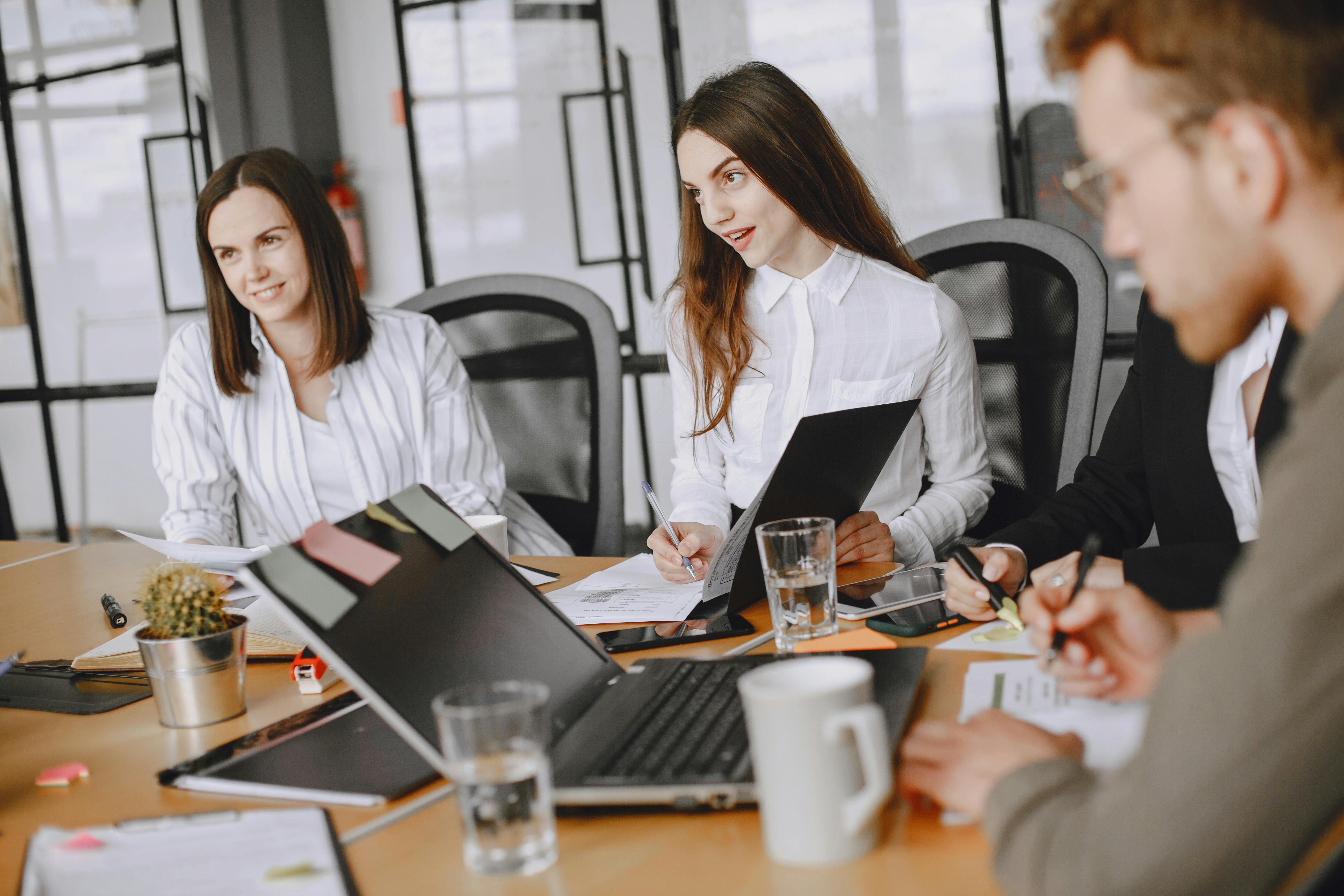 Graduate assistant sits in a company meeting