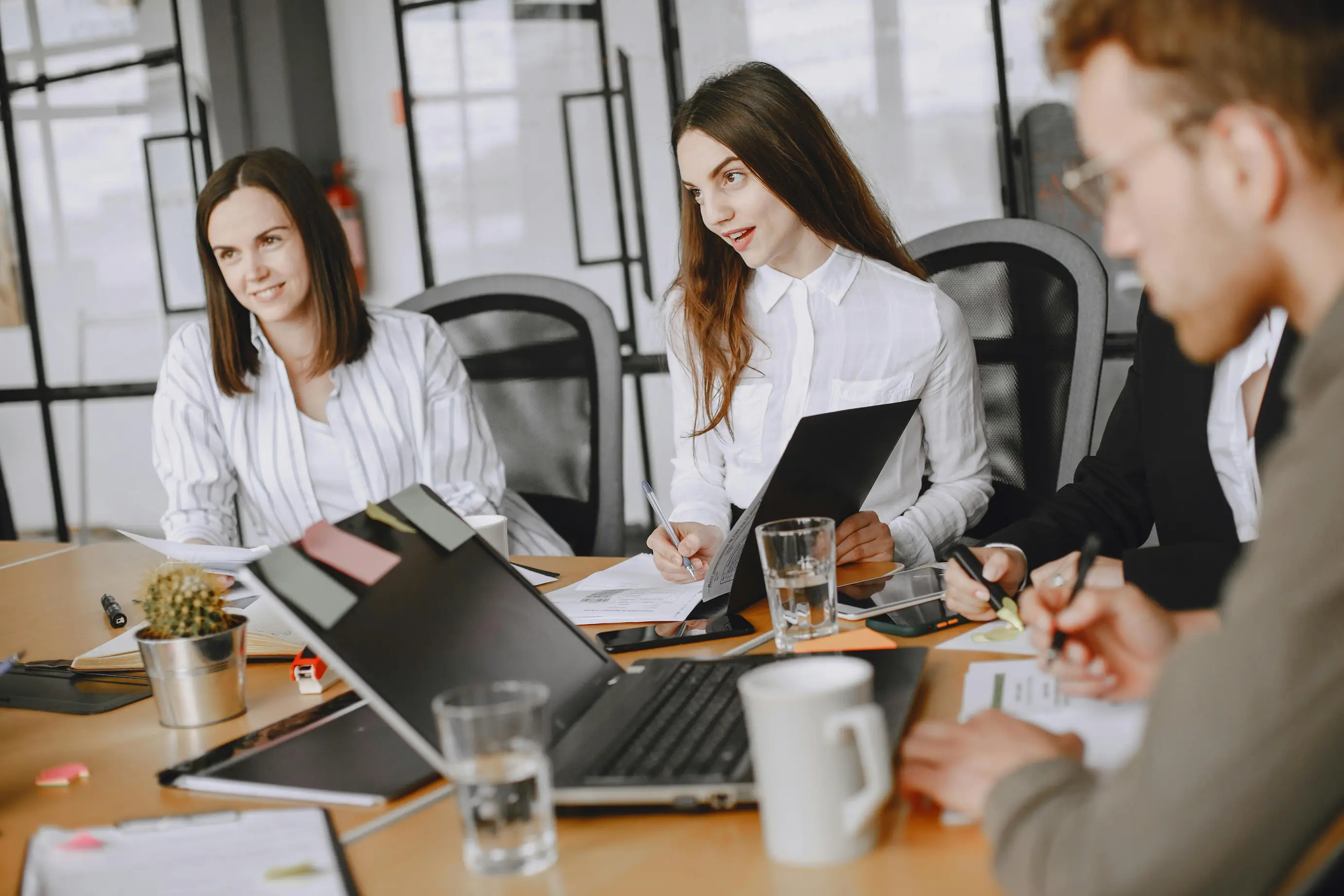 Graduate assistant sits in a company meeting