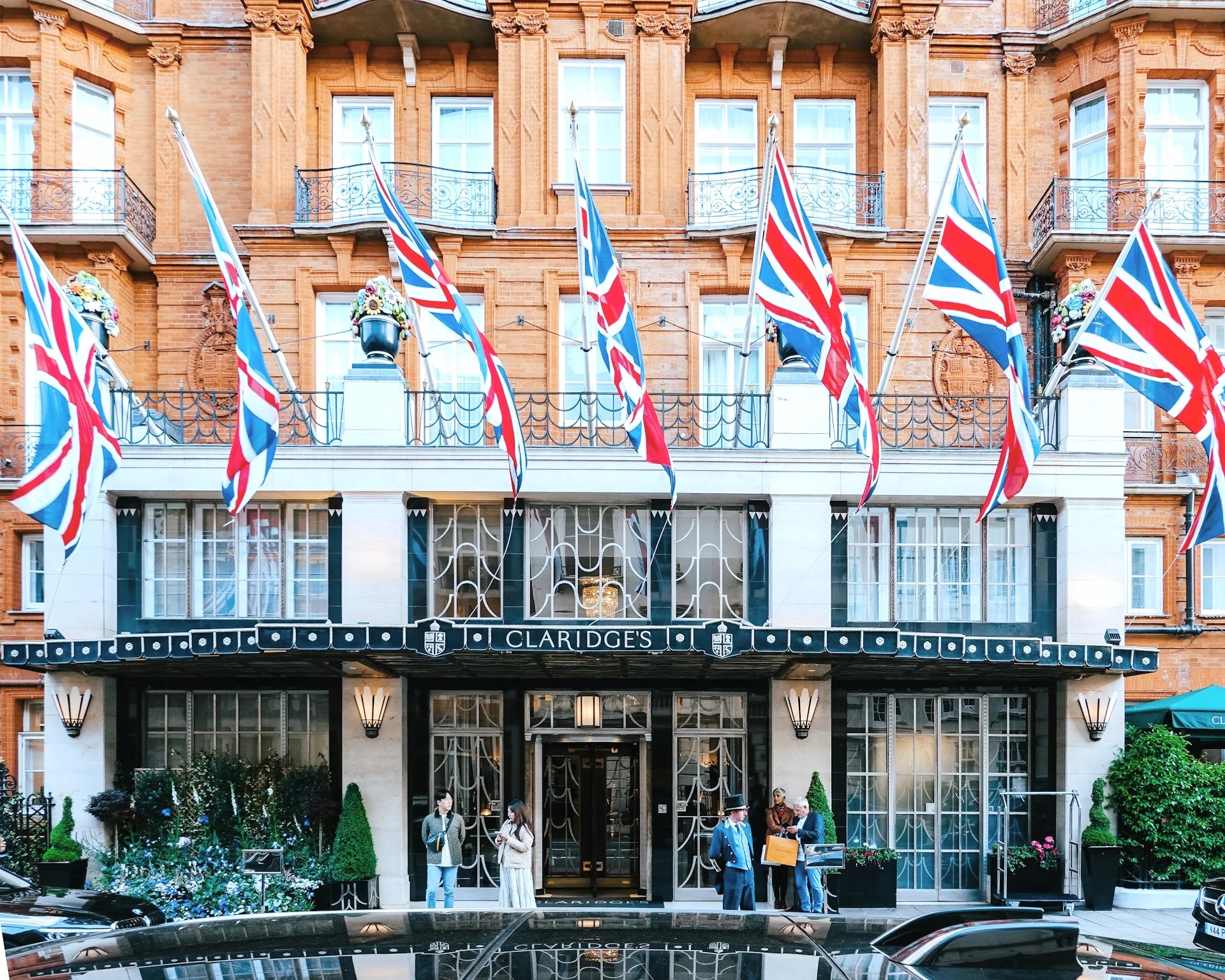 Facade of Claridge's hotel in Mayfair dressed with Union Jack flags
