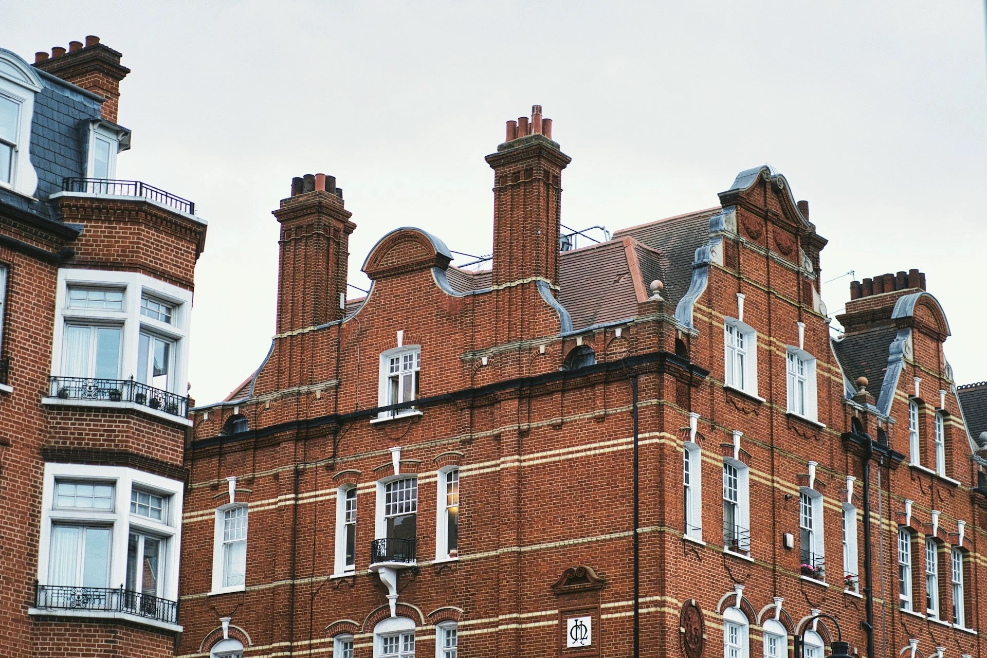 Ornate red-brick mansion block facade in a prime central London residential district