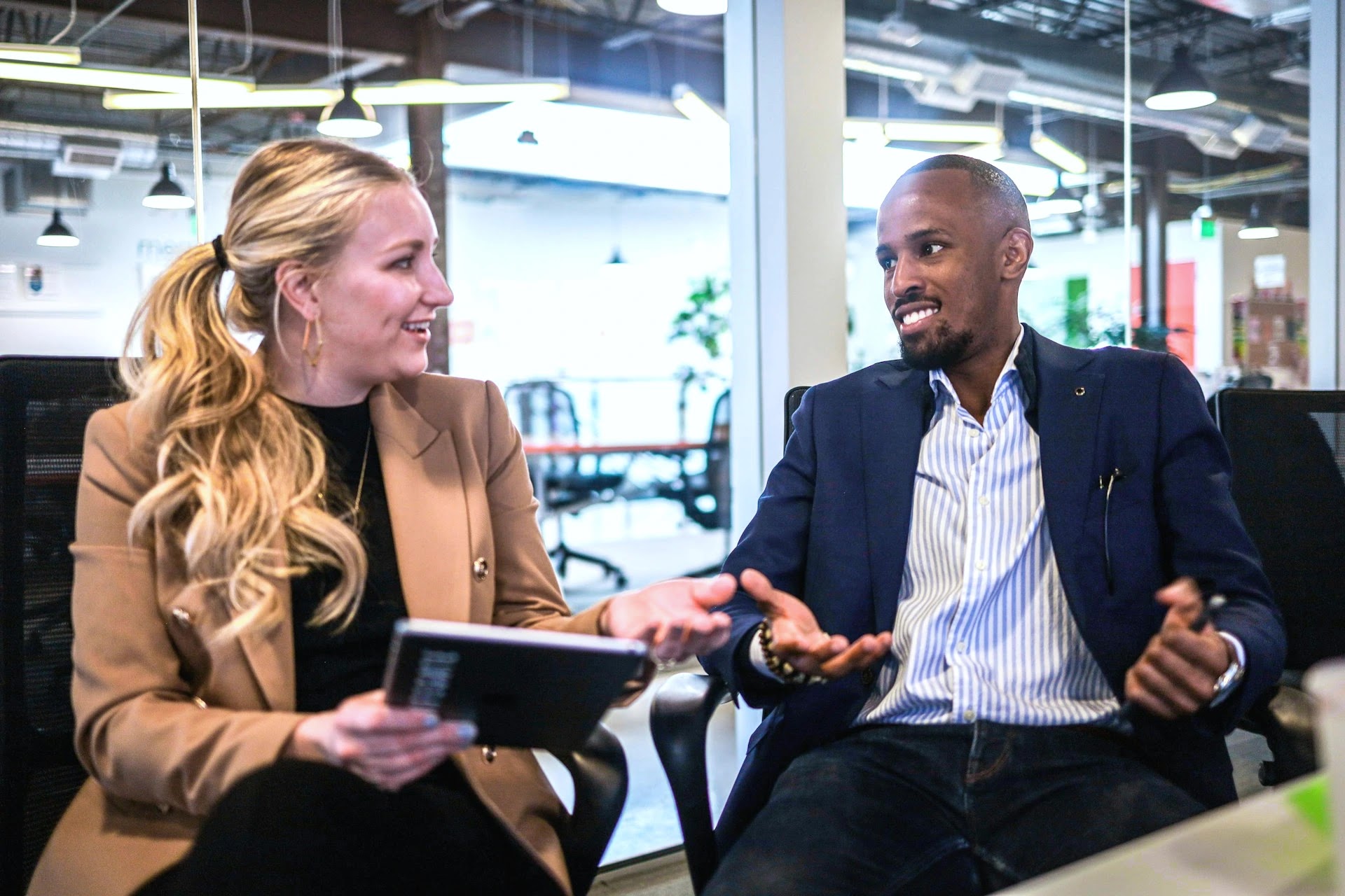Recruitment consultant and a start-up founder talking in a relaxed co-working office