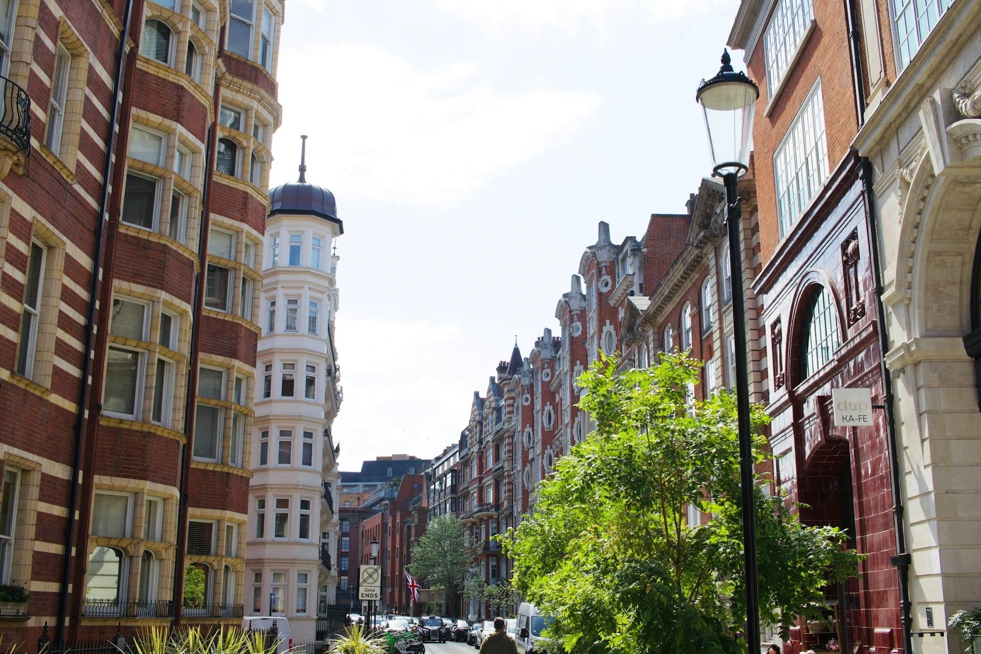 Red-brick mansion blocks on a leafy residential street in central London
